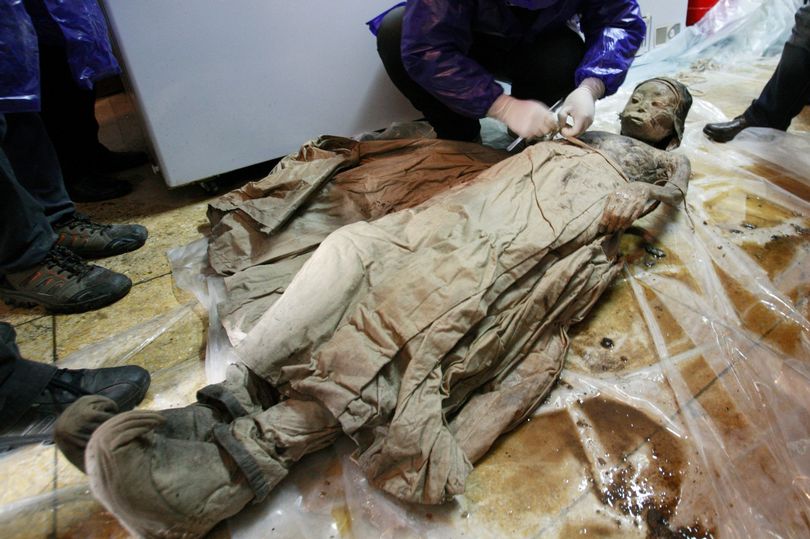 A perfectly preserved 700-year-old mummy in brown liquid